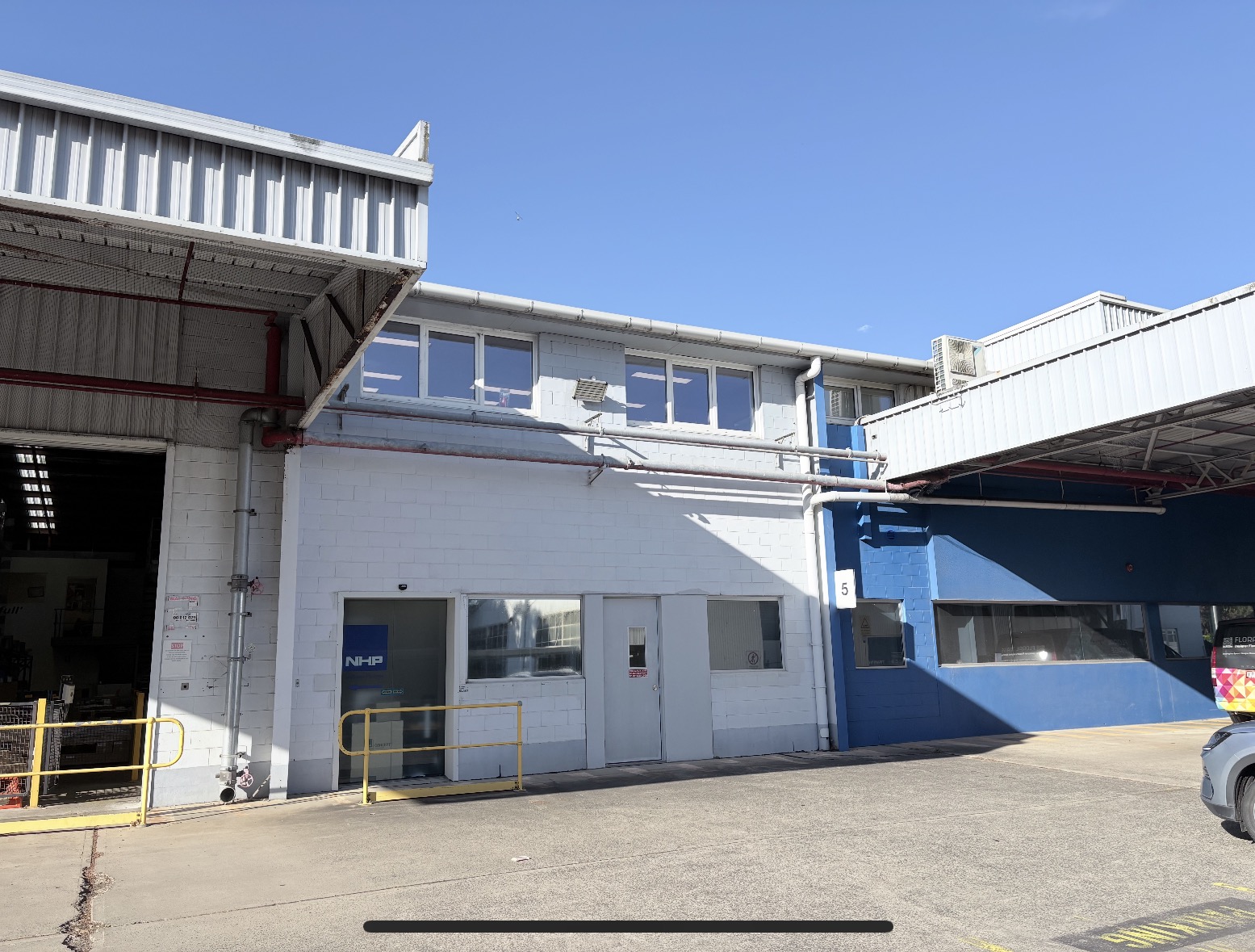 Workshop and loading annex with office windows and a glazed entry